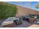 Outdoor patio furniture and seating area in a landscaped backyard at 493 Lace Haven Ct, Henderson, NV 89012