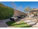 Relaxing backyard patio with seating area, fire pit, and artificial turf at 493 Lace Haven Ct, Henderson, NV 89012