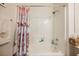 Updated bathroom with a shower/tub, wood cabinets, and a seashell-themed shower curtain at 493 Lace Haven Ct, Henderson, NV 89012