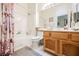 Clean and bright bathroom with wood cabinets and a shower/tub combo at 493 Lace Haven Ct, Henderson, NV 89012