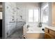 Modern bathroom shower with marble tile and glass enclosure at 493 Lace Haven Ct, Henderson, NV 89012