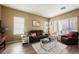 Relaxing living room with comfortable seating, large windows, and a cozy atmosphere at 493 Lace Haven Ct, Henderson, NV 89012