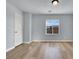 Well-lit bedroom with wood-look floors and a view from the window at 5089 Sagelyn St, Las Vegas, NV 89122