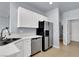 Kitchen with stainless steel appliances, white cabinets, and a pantry at 5089 Sagelyn St, Las Vegas, NV 89122