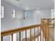 Upstairs hall with wood railing and light gray walls at 5089 Sagelyn St, Las Vegas, NV 89122