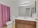 Bathroom with a shower/tub combo, vanity, and pink curtain at 513 Chandler St, Henderson, NV 89014