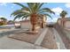 Single-story house with a palm tree, driveway, and boat at 513 Chandler St, Henderson, NV 89014