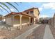 Two-story house with covered carport, gated driveway, and landscaped yard at 513 Chandler St, Henderson, NV 89014