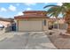 Two-story house with attached garage and palm tree at 513 Chandler St, Henderson, NV 89014