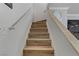 Modern stairs with wood-look laminate treads and white risers at 513 Chandler St, Henderson, NV 89014