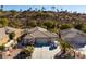 Single-story house with a three-car garage and desert landscaping, aerial view at 526 Highland View Ct, Mesquite, NV 89027