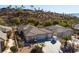 Single-story house with a three-car garage and desert landscaping, aerial view at 526 Highland View Ct, Mesquite, NV 89027