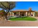 Spacious backyard featuring artificial turf, desert landscaping, and a covered patio at 526 Highland View Ct, Mesquite, NV 89027