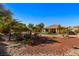 Backyard with grass, gravel, and mature trees at 526 Highland View Ct, Mesquite, NV 89027