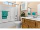 Cozy bathroom featuring a shower-tub combo, wooden vanity, and storage cabinet at 526 Highland View Ct, Mesquite, NV 89027