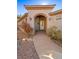 Covered entryway with arched walkway and access to the front door at 526 Highland View Ct, Mesquite, NV 89027