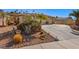 Landscaped front yard with drought-tolerant plants and a long driveway at 526 Highland View Ct, Mesquite, NV 89027