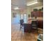 Community kitchen with wood cabinets, island, and seating at 5751 E Hacienda Ave # 244, Las Vegas, NV 89122