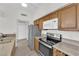 Modern kitchen with stainless steel appliances and wood cabinets at 6205 Hargrove Ave, Las Vegas, NV 89107