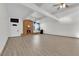 Spacious living room with brick fireplace and wood-look floors at 6205 Hargrove Ave, Las Vegas, NV 89107