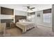 Main bedroom with ceiling fan, large bed and ensuite bathroom at 651 Penshaw Bridge Ave, Las Vegas, NV 89178