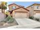 Two-story house with attached garage and landscaped yard at 651 Penshaw Bridge Ave, Las Vegas, NV 89178