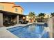 Relaxing pool with patio furniture and adjacent house at 651 Penshaw Bridge Ave, Las Vegas, NV 89178