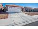 Two-car garage with white door and driveway at 7528 Pinto Bluff St, Las Vegas, NV 89131