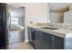 Kitchen with gray cabinets and granite counters at 7528 Pinto Bluff St, Las Vegas, NV 89131