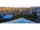 Hot tub, seating, and artificial turf in this backyard at 8606 Dusty Quail Dr, Las Vegas, NV 89148