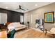 Light and airy main bedroom with mid-century modern furniture and ceiling fan at 8606 Dusty Quail Dr, Las Vegas, NV 89148