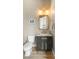 Modern powder room with dark vanity, gold fixtures and marble countertop at 8606 Dusty Quail Dr, Las Vegas, NV 89148