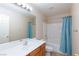 Bathroom with tub shower combo and wood vanity at 8789 Ashley Park Ave, Las Vegas, NV 89148