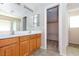 Bathroom with double vanity, large mirror, and walk-in closet at 8789 Ashley Park Ave, Las Vegas, NV 89148