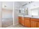 Bathroom with double vanity, wood cabinets, and mirror at 8789 Ashley Park Ave, Las Vegas, NV 89148