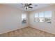 Bedroom with large windows and ceiling fan at 8789 Ashley Park Ave, Las Vegas, NV 89148