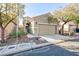 Two-story house with attached garage and desert landscaping at 8789 Ashley Park Ave, Las Vegas, NV 89148