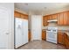 Kitchen with wood cabinets and white appliances at 8789 Ashley Park Ave, Las Vegas, NV 89148