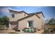 Two-story home with a modern design, attached garage, and desert landscaping at 9268 Copernicus Ave, Las Vegas, NV 89143