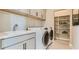 Bright laundry room with washer, dryer, and ample storage at 9268 Copernicus Ave, Las Vegas, NV 89143