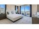 Main bedroom with plush bed, large window, and private access to balcony at 9280 Copernicus Ave, Las Vegas, NV 89143