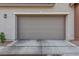 Attached garage with gray door and concrete driveway at 965 Nevada State Dr # 15103, Henderson, NV 89002