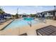 Community pool with lounge chairs and umbrellas at 965 Nevada State Dr # 15103, Henderson, NV 89002