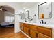 Bright bathroom with double sinks, modern fixtures, and an open archway to the bedroom at 9741 Horizon Hills Dr, Las Vegas, NV 89117