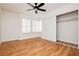 Bedroom with window, hard floors, shutters, ceiling fan and closet at 9741 Horizon Hills Dr, Las Vegas, NV 89117