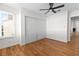 Well-lit bedroom with hardwood floors, a large closet, and ceiling fan at 9741 Horizon Hills Dr, Las Vegas, NV 89117