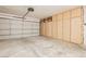 Spacious garage with ample storage and a functional garage door at 9741 Horizon Hills Dr, Las Vegas, NV 89117