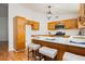 Charming kitchen with wooden cabinets, white counters, a gas range, and island seating at 9741 Horizon Hills Dr, Las Vegas, NV 89117