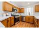 Lovely kitchen with wood cabinets, stainless appliances, and a bright window at 9741 Horizon Hills Dr, Las Vegas, NV 89117