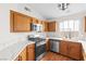 Modern kitchen with wood cabinets, quartz countertops, and stainless steel appliances at 9741 Horizon Hills Dr, Las Vegas, NV 89117